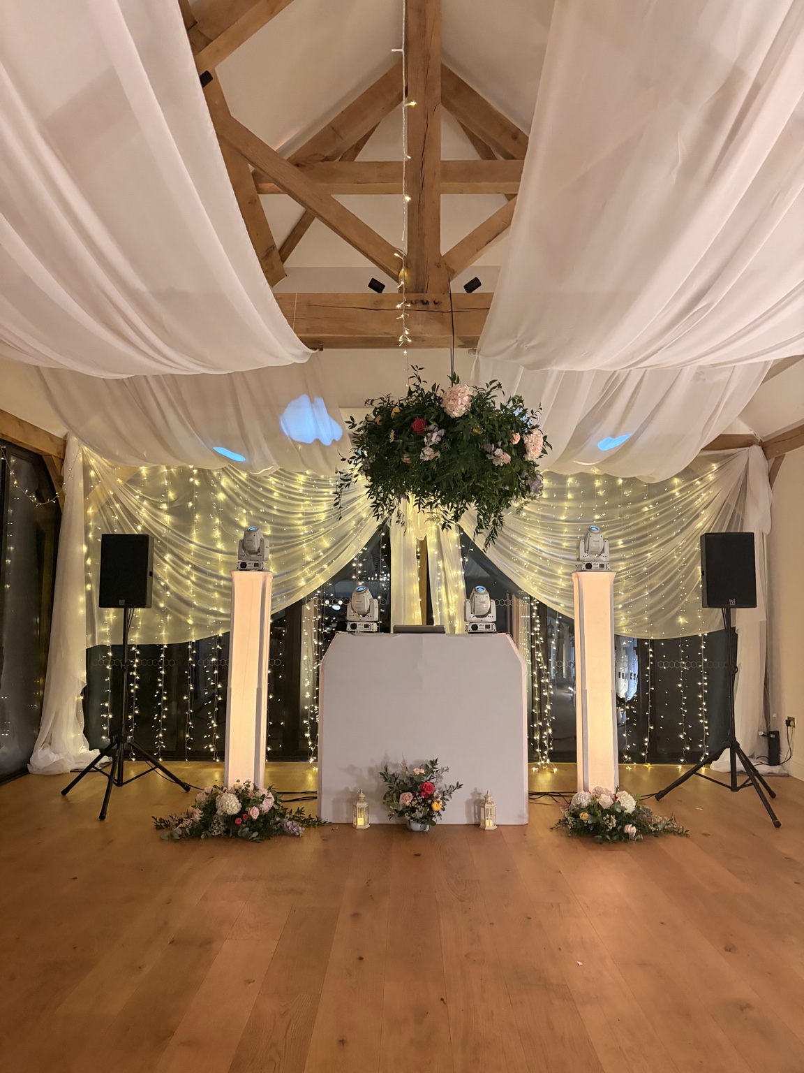 Sussex DJ Company setup beneath the draped ceiling and flowers at Alfriston Gardens