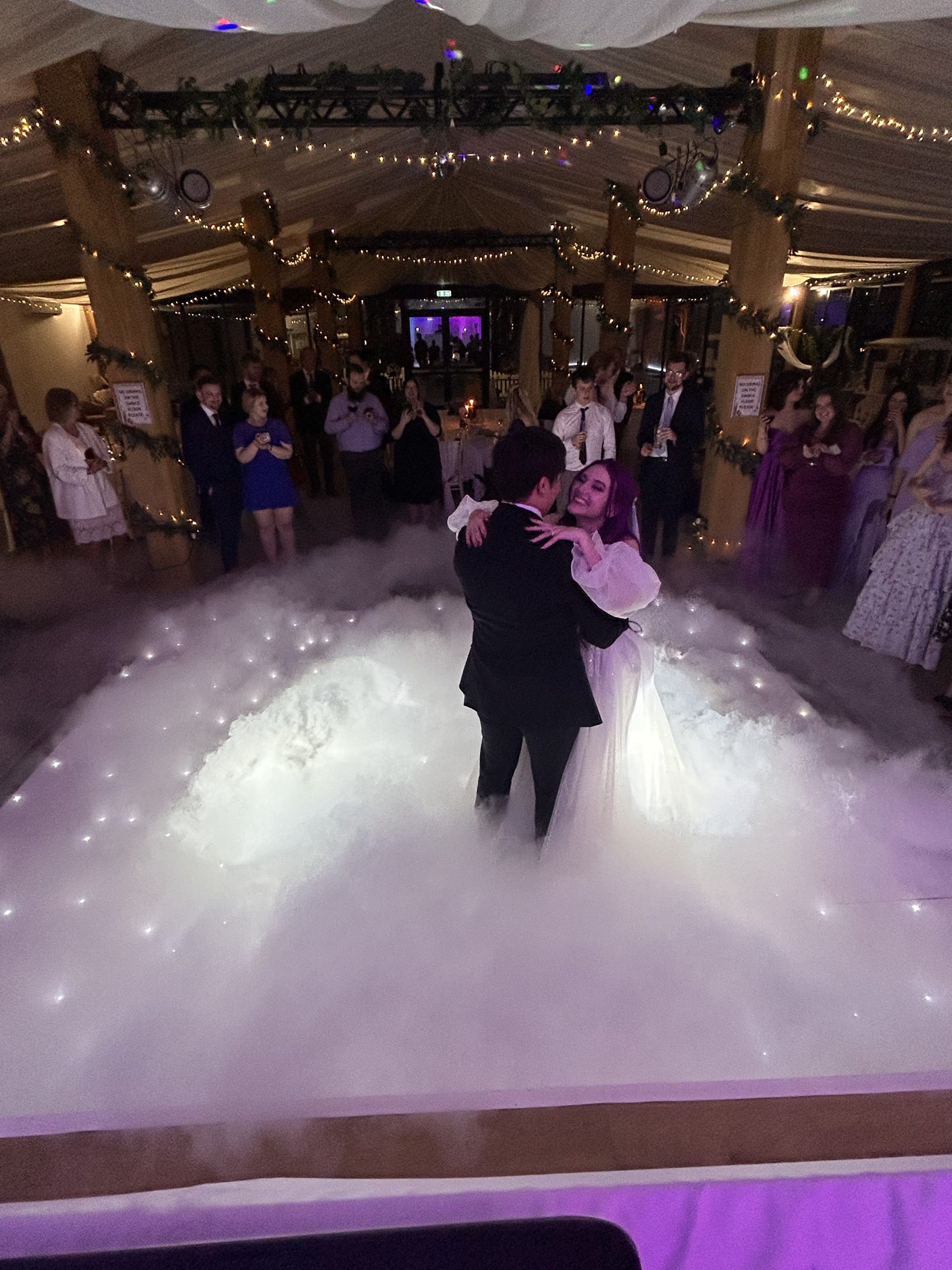 sdc-clouds Couple dancing on a lit floor with low-lying cloud effect